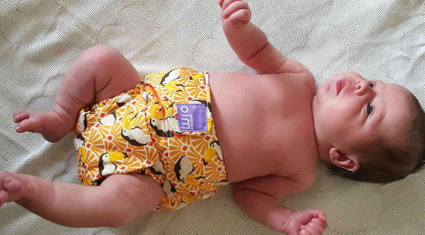 baby in reusable nappy after cleaning him